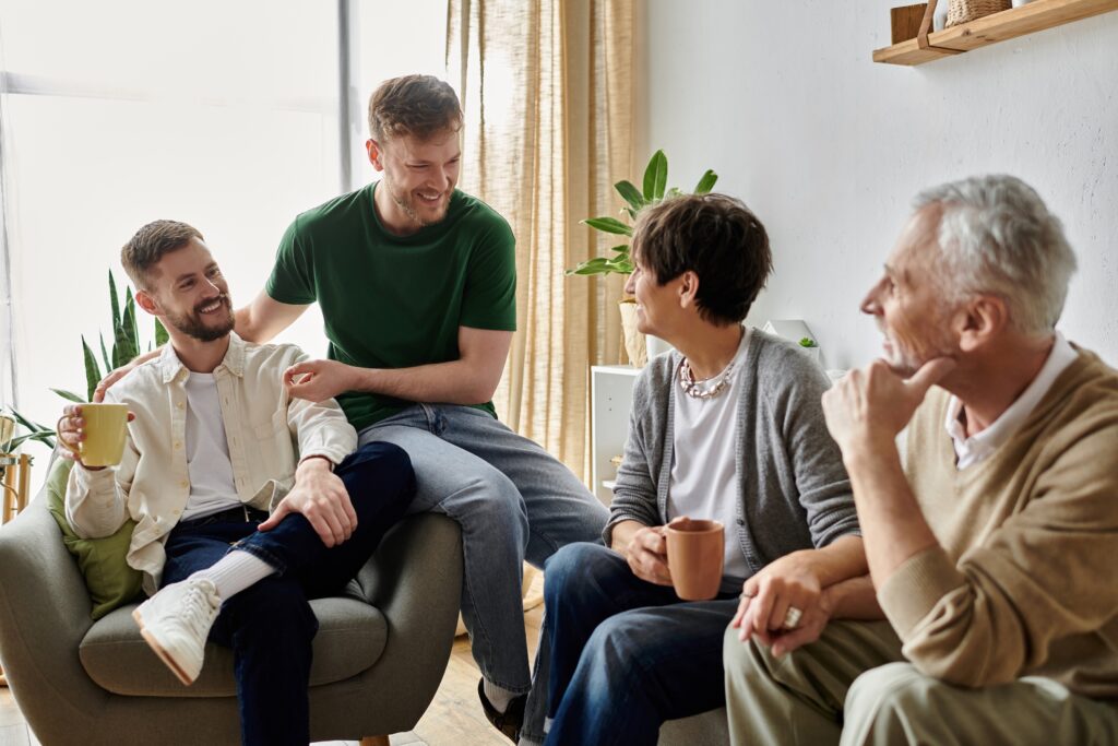Talking to family about money: five conversations that can't wait Two adult sons talking to family about money with their parents over coffee in a living room